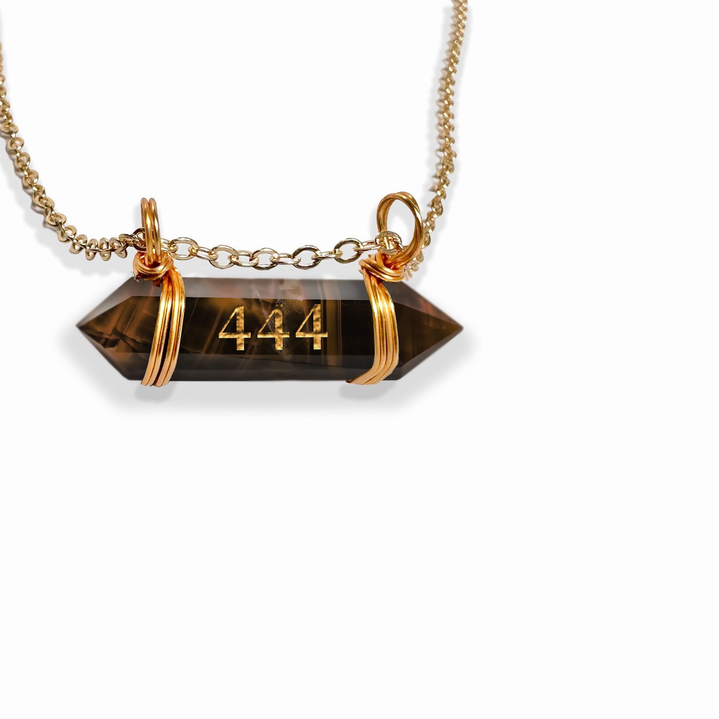 A tiger's eye double-terminated crystal, engraved with the angel number "444." The crystal showcases its signature golden-brown bands and polished surface. It is elegantly suspended from a gold chain, adding a touch of luxury to the natural beauty of the stone. The engraving is clear and delicate, standing out against the rich tones of the tiger's eye. The overall design conveys a sense of strength, protection, and spiritual grounding associated with both the crystal and the angel number.