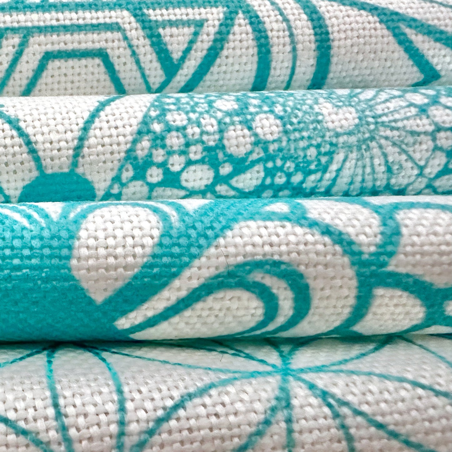 A close-up view of the Cloth Crystal Grid Cotton-Linen fabric, showcasing the textured weave of the cotton-linen blend. The image highlights the medium-thick material, with visible fibers interlacing to create a durable yet soft surface. The turquoise lines design stand out clearly against the natural white background, emphasizing the fabric's quality and slight thickness, perfect for holding crystals in place during spiritual or meditative practices.